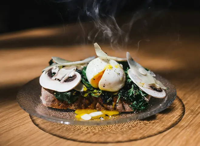 Dish served with meat and mushrooms atop.